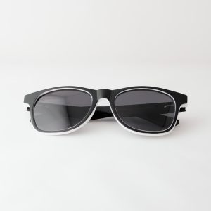 Bamboo sunglasses , folded . Dark grey lenses, polarized, and matte black and white frame. Designed in Canada