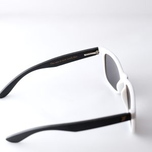 Bamboo sunglasses , folded out. The arm reads : " the sun is new each day"Dark grey lenses, polarized, and matte black and white frame. Designed in Canada