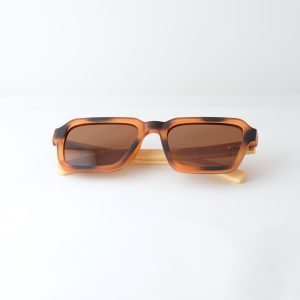 Carpathia bamboo sunglasses folded on a white background, with tortie frame, brown lenses and light brown natural bamboo arms.
