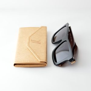 bamboo sunglasses on white background, folded next to case; with brown arms and matte black frames. Smokey dark grey lenses. Designed in Canada