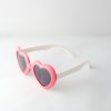 kids sunglasses frame is heart shaped and red, arms are white